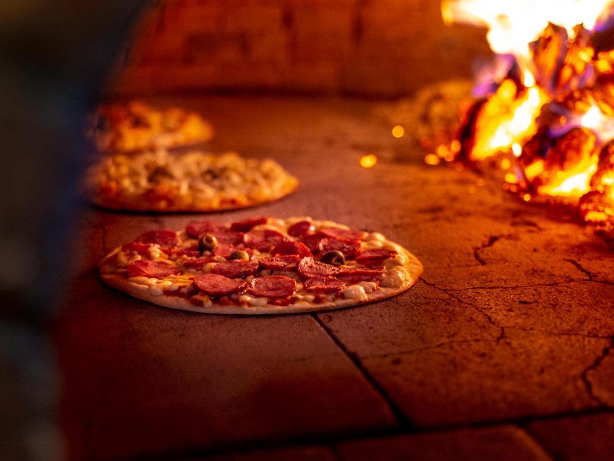 Ocean Palace All Inclusive Premium Natal Ngoại thất bức ảnh Pizza being cooked in a wood-fired oven